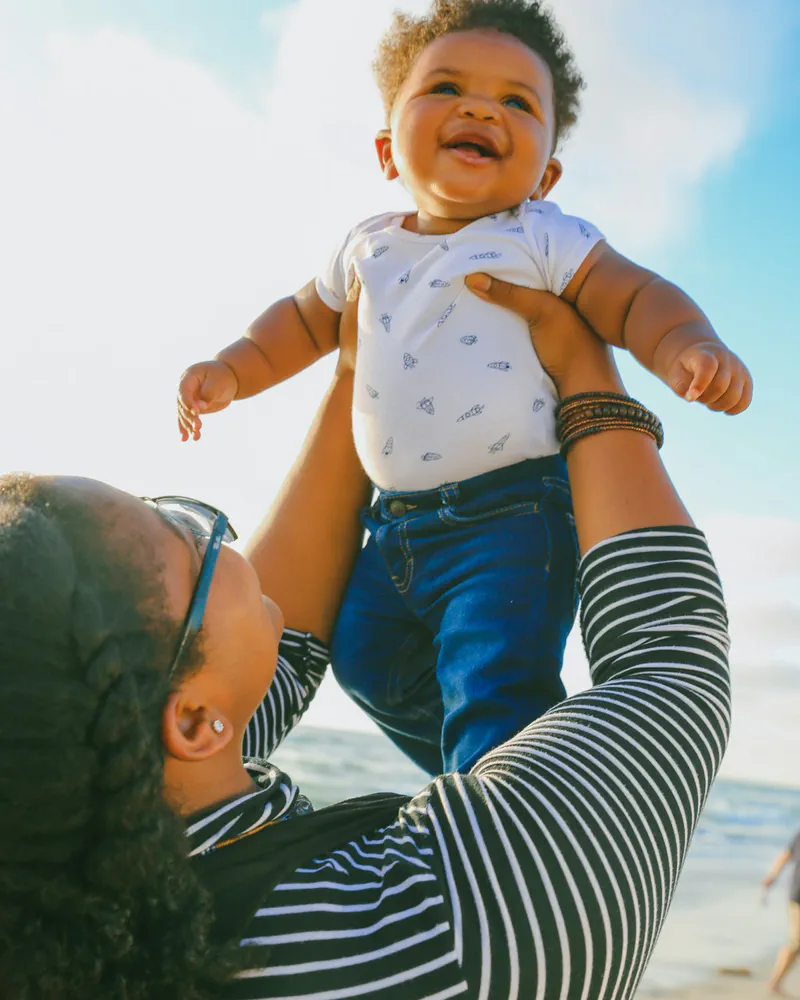 A parent holding their baby close
